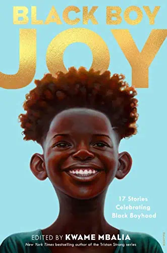 Joyful Black boy with natural curly hair smiling, celebrating Black boyhood.