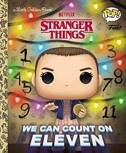 Funko Pop! figure of Eleven from Stranger Things with colorful holiday lights.