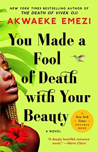 A woman with vibrant jewelry and red flowers, symbolizing beauty and strength, against a bright gree.