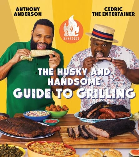 Two men enjoying grilling with BBQ meats and sides at Brass & Wool.